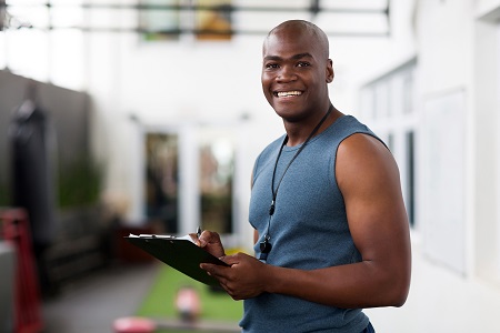 personal trainer with a clip board